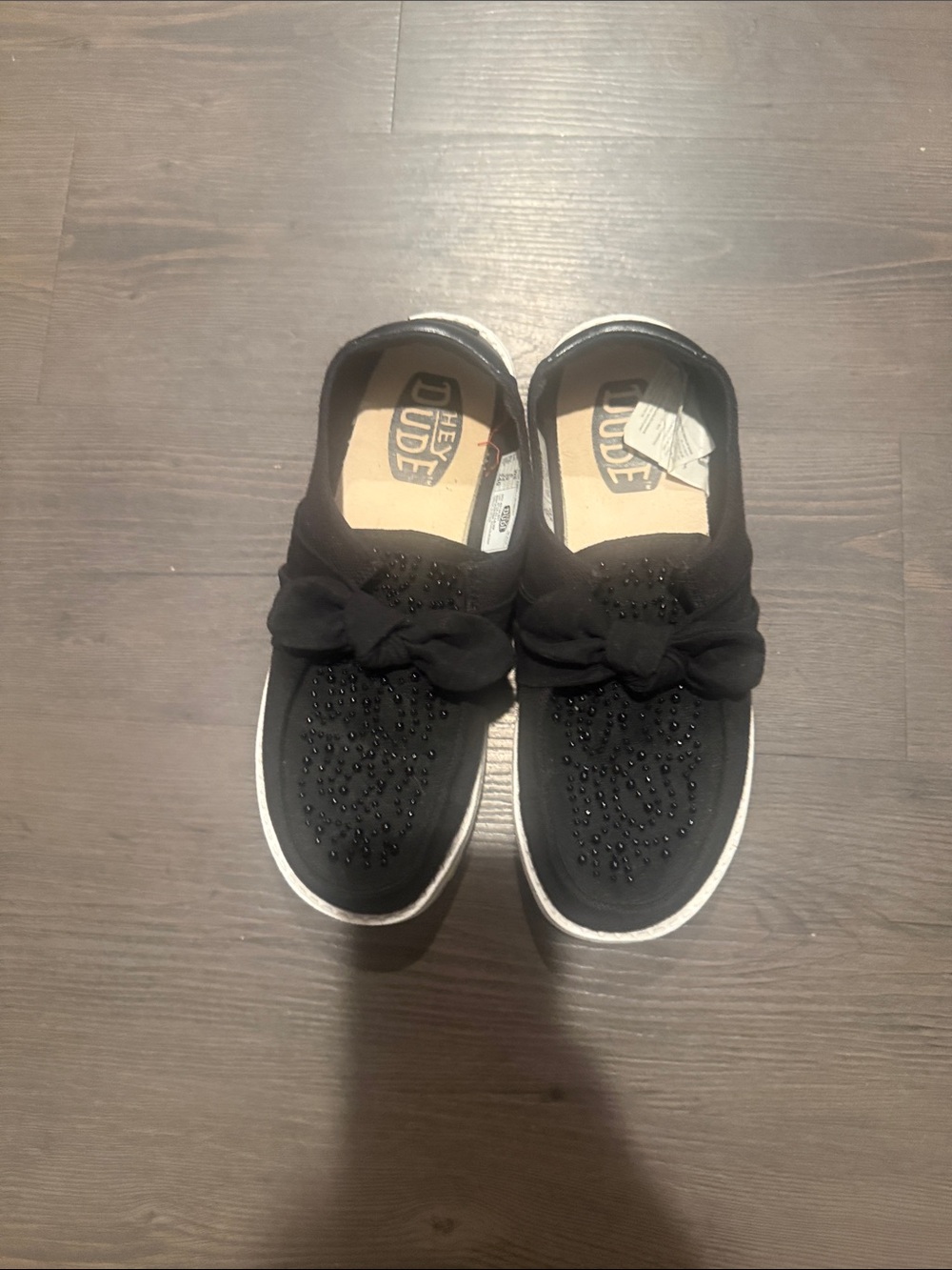Hey Dude women size 8 Black Slip-On Sneakers with Decorative Bow and Beads